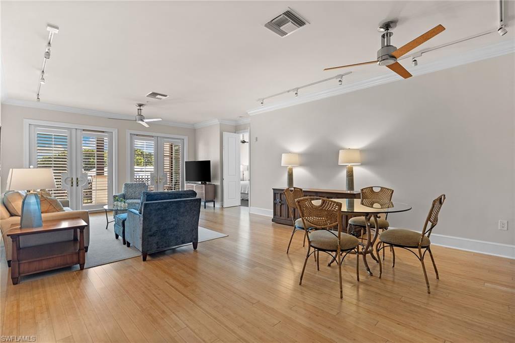 780 5th Avenue South, Unit 306 Naples, FL 34102 - Photo 8 of 31 a view of a dining room with furniture and wooden floor