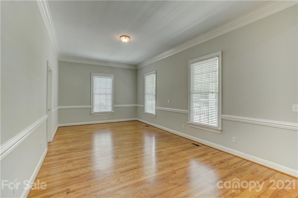 548 Glen Walk Drive Fort Mill, SC 29708 - Photo 11 of 48 a view of an empty room with wooden floor and a window