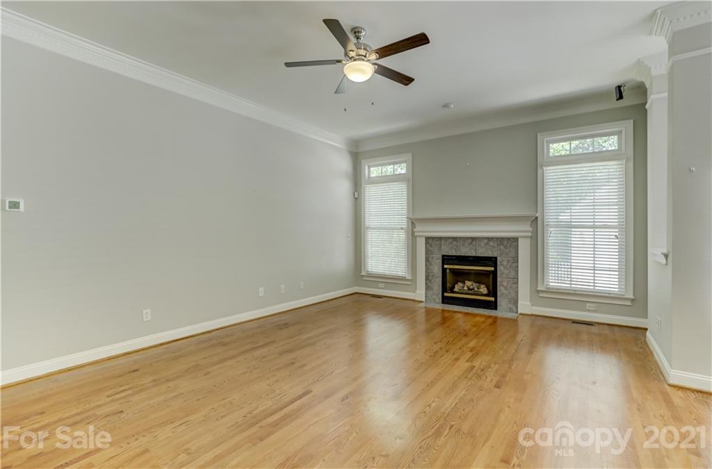 548 Glen Walk Drive Fort Mill, SC 29708 - Photo 14 of 48 a view of a livingroom with a fireplace a ceiling fan and hardwood floor