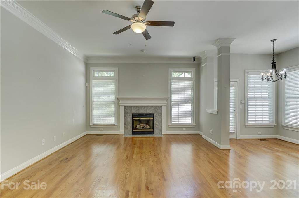 548 Glen Walk Drive Fort Mill, SC 29708 - Photo 17 of 48 a view of a livingroom with a fireplace a ceiling fan and windows