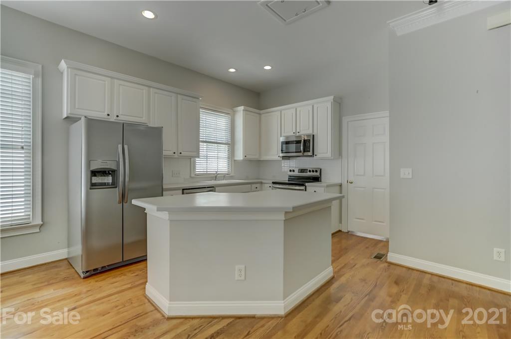 548 Glen Walk Drive Fort Mill, SC 29708 - Photo 18 of 48 a kitchen with kitchen island a sink stainless steel appliances and cabinets