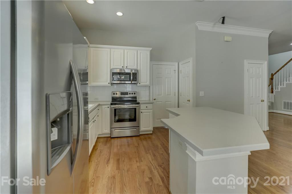 548 Glen Walk Drive Fort Mill, SC 29708 - Photo 19 of 48 a kitchen with stainless steel appliances a refrigerator and a stove top oven