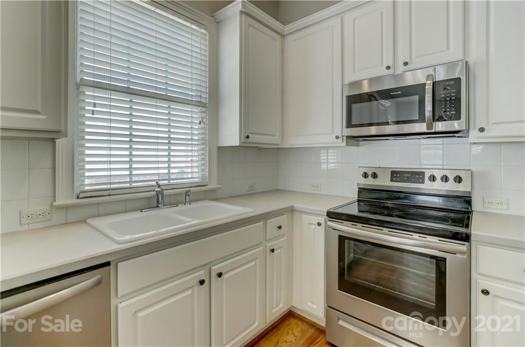 548 Glen Walk Drive Fort Mill, SC 29708 - Photo 21 of 48 a kitchen with granite countertop white cabinets and appliances