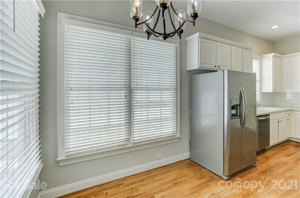 548 Glen Walk Drive Fort Mill, SC 29708 - Photo 25 of 48 a view of a refrigerator in kitchen and an empty room