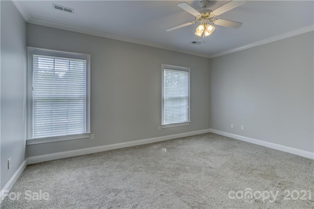 548 Glen Walk Drive Fort Mill, SC 29708 - Photo 33 of 48 an empty room with a window and a fan