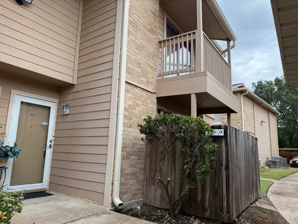 a view of front door and potted plants