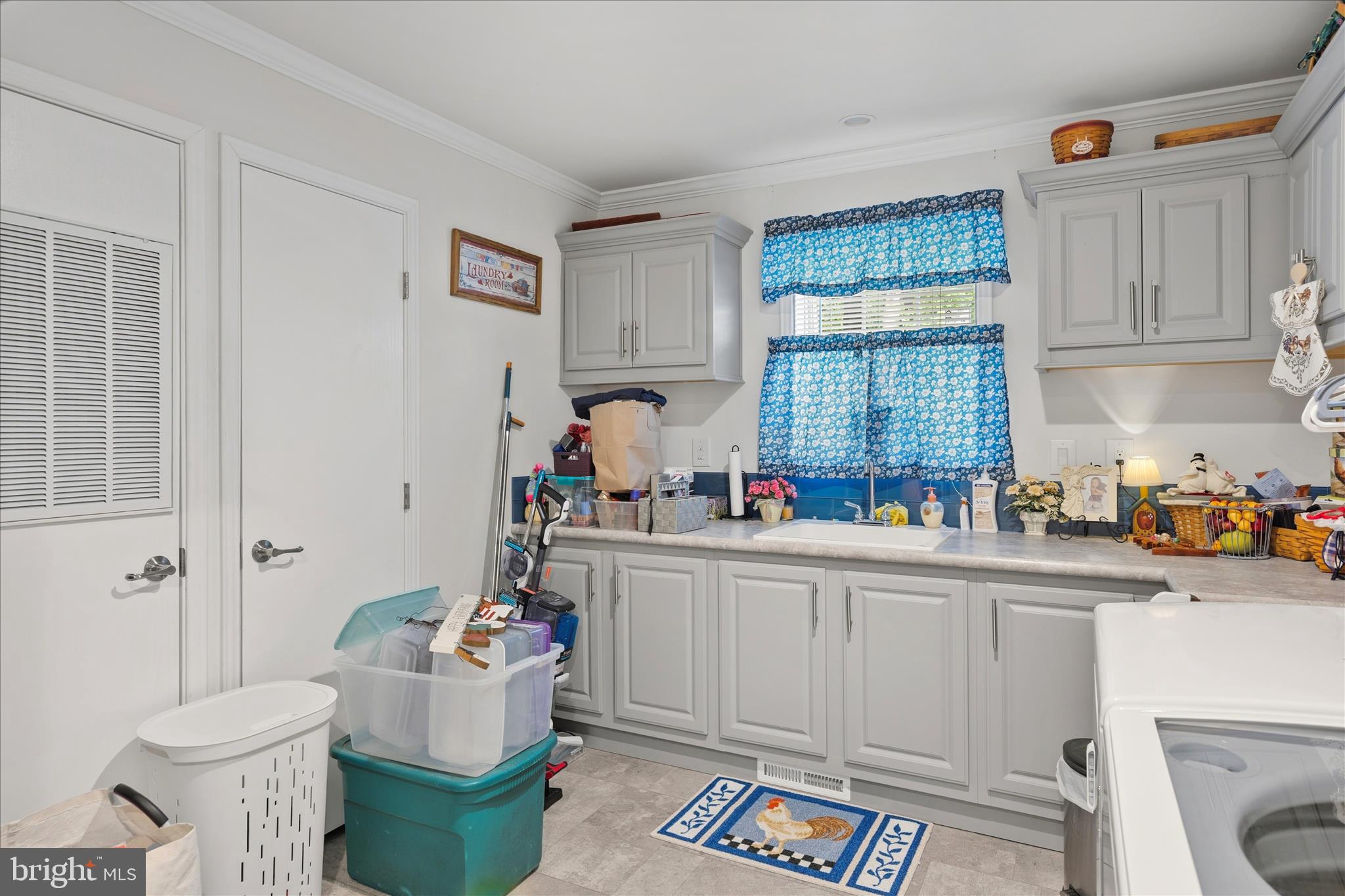 21933 Conrail Road Seaford, DE 19973 - Photo 12 of 35 a kitchen with a sink and cabinets