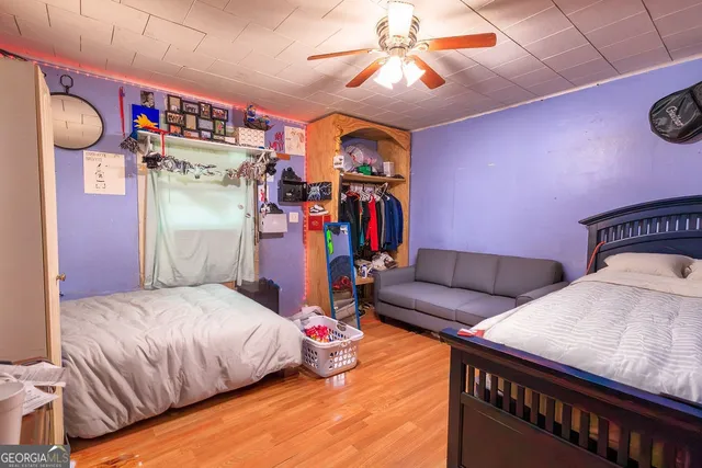 a bedroom with bed and a chandelier