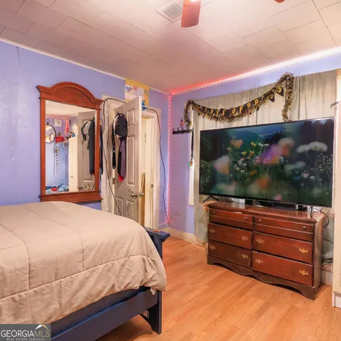 a bedroom with a bed and a flat screen tv