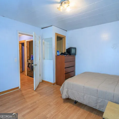 a bedroom with a bed and a mirror