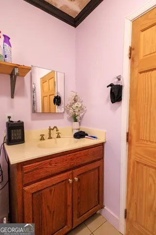 a bathroom with a sink vanity and mirror