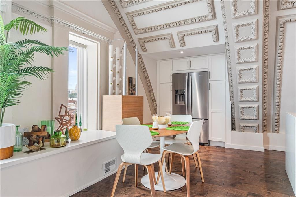2132 Sarah Street, Unit 207 Pittsburgh, PA 15203 - Photo 20 of 50 Stainless steel refrigerator is tucked away with pantry space just beyond the dining area.