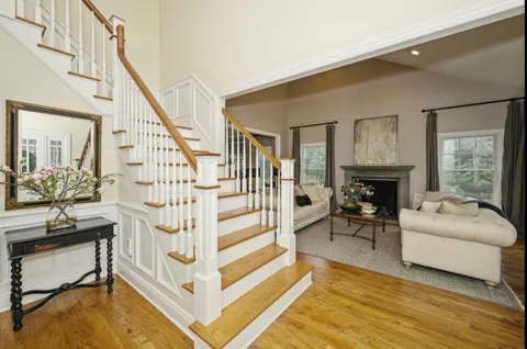 a view of entryway livingroom and hall with wooden floor