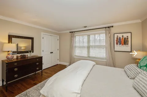 a bedroom with a bed and a flat screen television