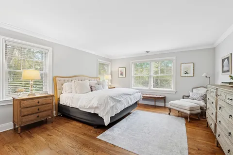 a bed room with a bed and a chair