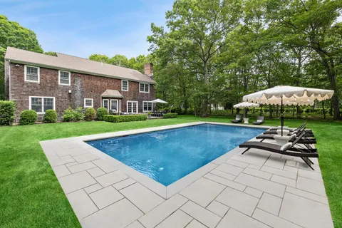 a view of a house with swimming pool and sitting area