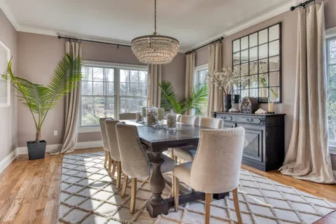 a view of a dining room with furniture wooden floor and chandelier