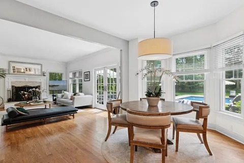a living room with fireplace furniture and a large window
