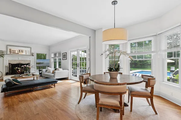 a living room with fireplace furniture and a large window