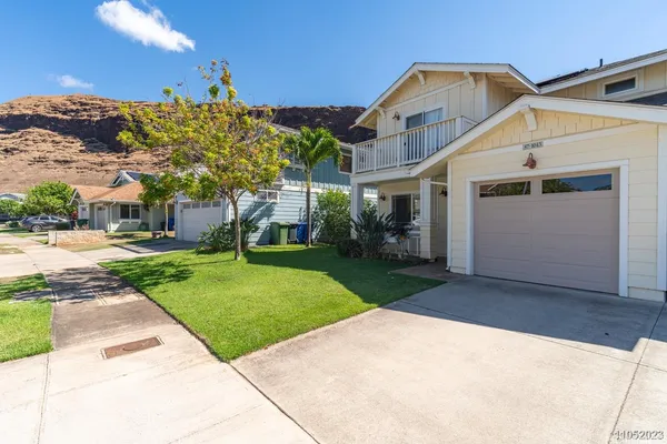 a view of a white house with a yard