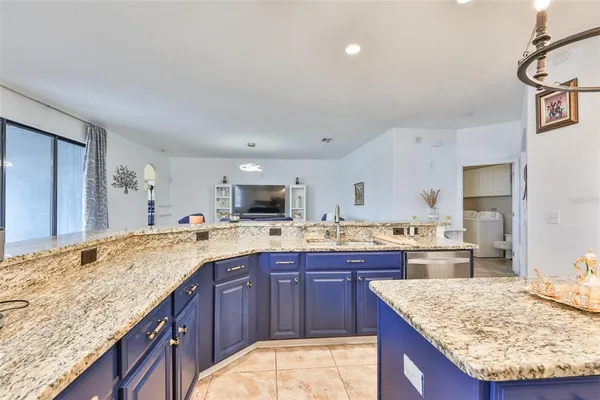 a kitchen with a stove sink and cabinets