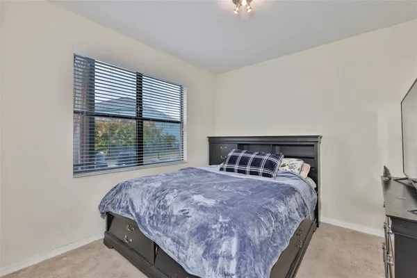 a bedroom with a bed and a large window