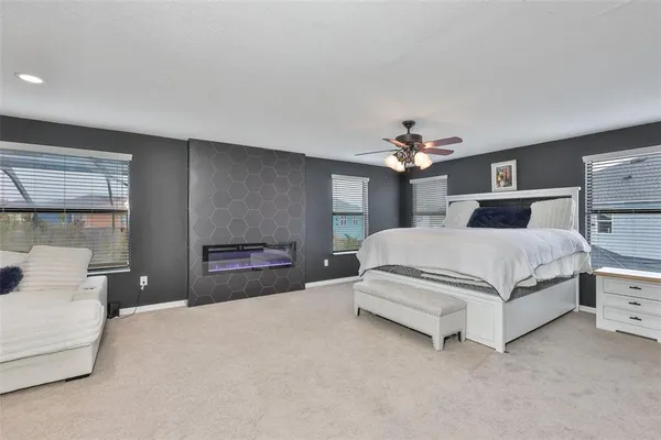 a bedroom with a large bed and a chandelier