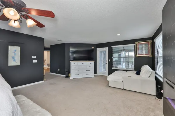 a bedroom with furniture and large windows
