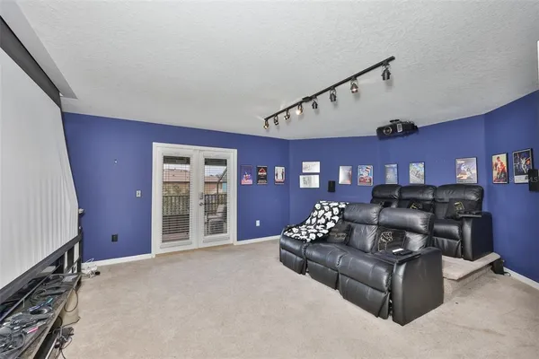 a living room with furniture gym equipment and a flat screen tv