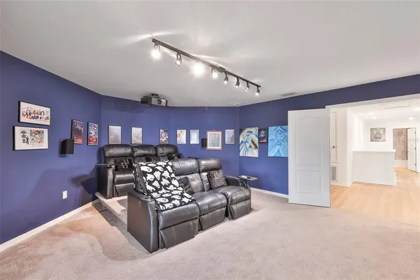 a living room with furniture and a wall painting