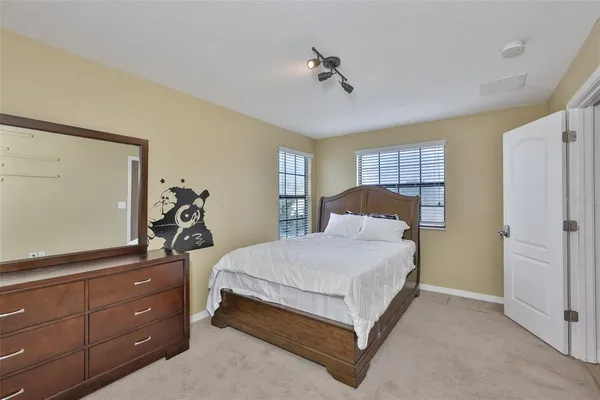 a bedroom with a bed and a dresser