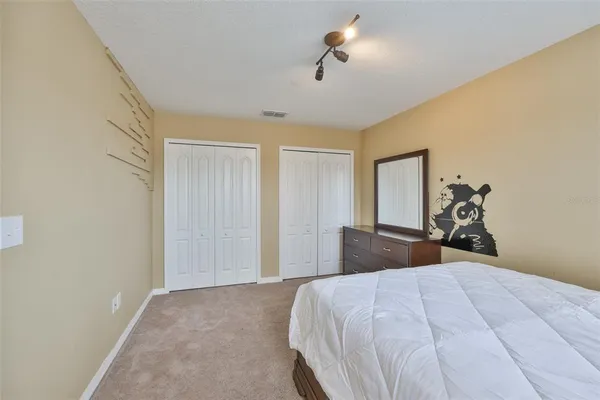 a bedroom with a bed and a dresser