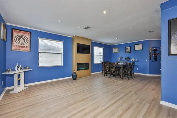 a view of a livingroom with furniture a dinning table and chairs