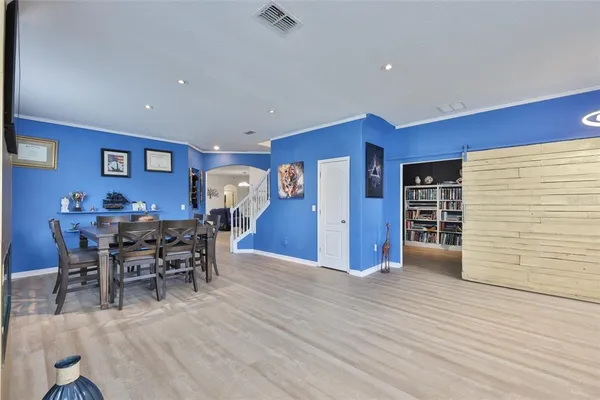 a view of a dining room with furniture and wooden floor