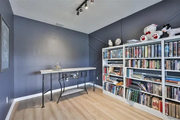 a bedroom with furniture book shelf and a book shelf