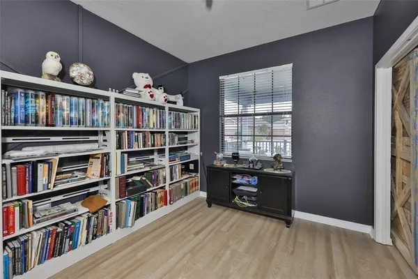 a room with bookshelf and a window