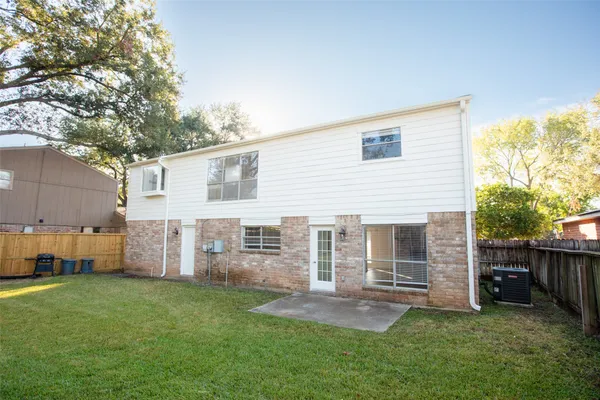 a view of a house with a backyard