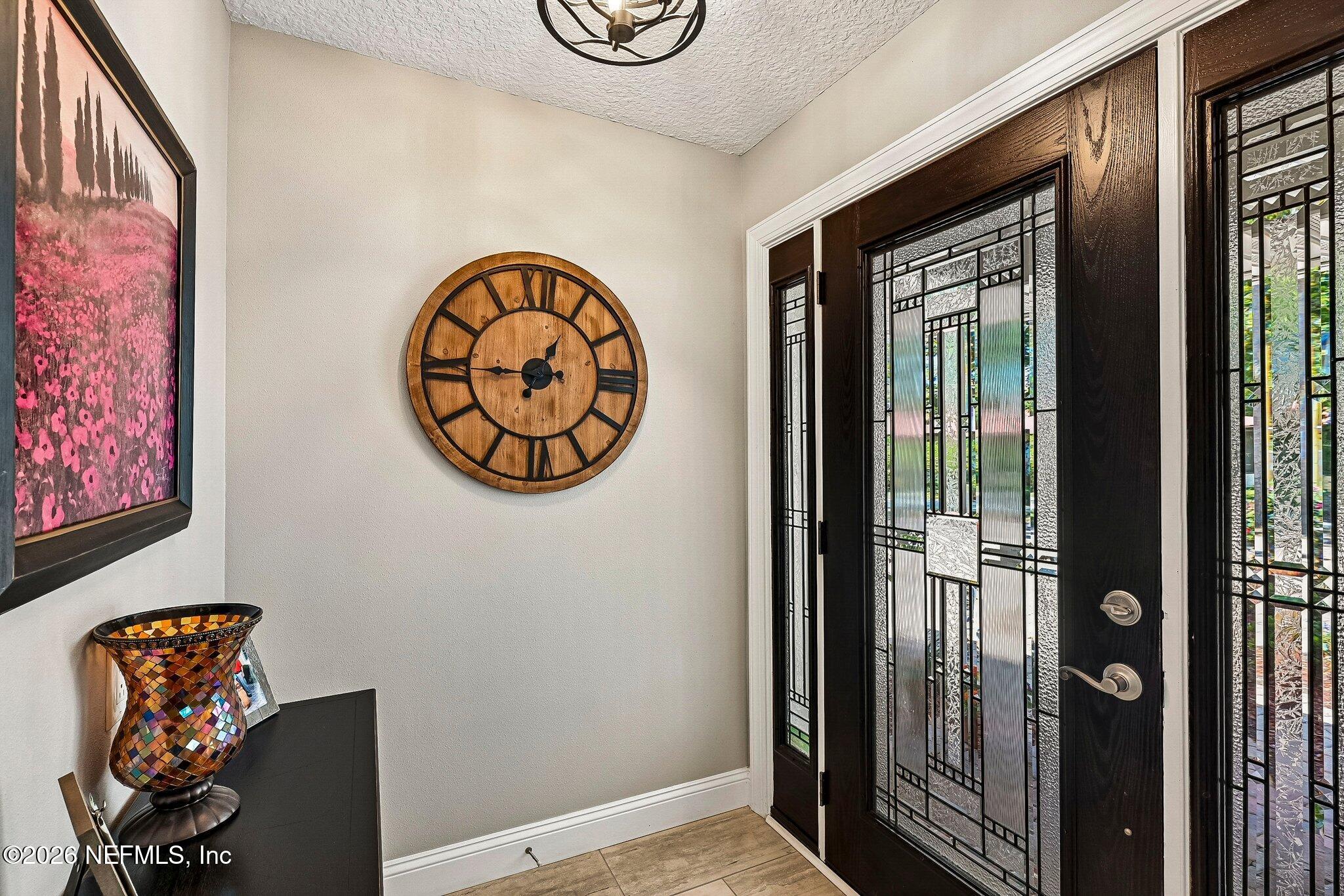 4745 Raggedy Point Road Fleming Island, FL 32003 - Photo 13 of 106 an entryway with a table and a chandelier