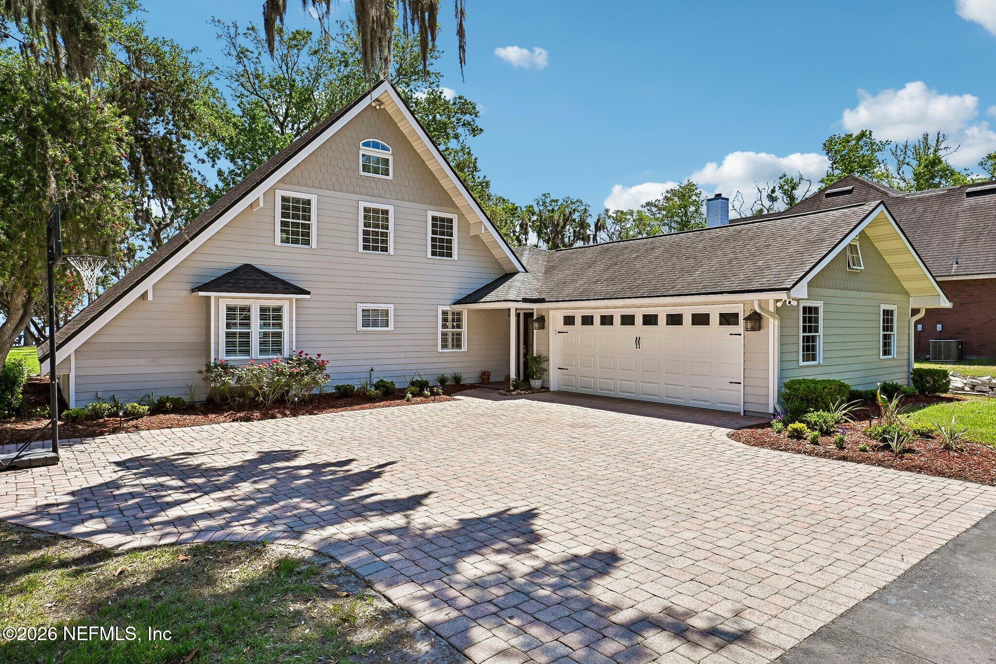 4745 Raggedy Point Road Fleming Island, FL 32003 - Photo 2 of 106 a front view of a house with a yard and garage