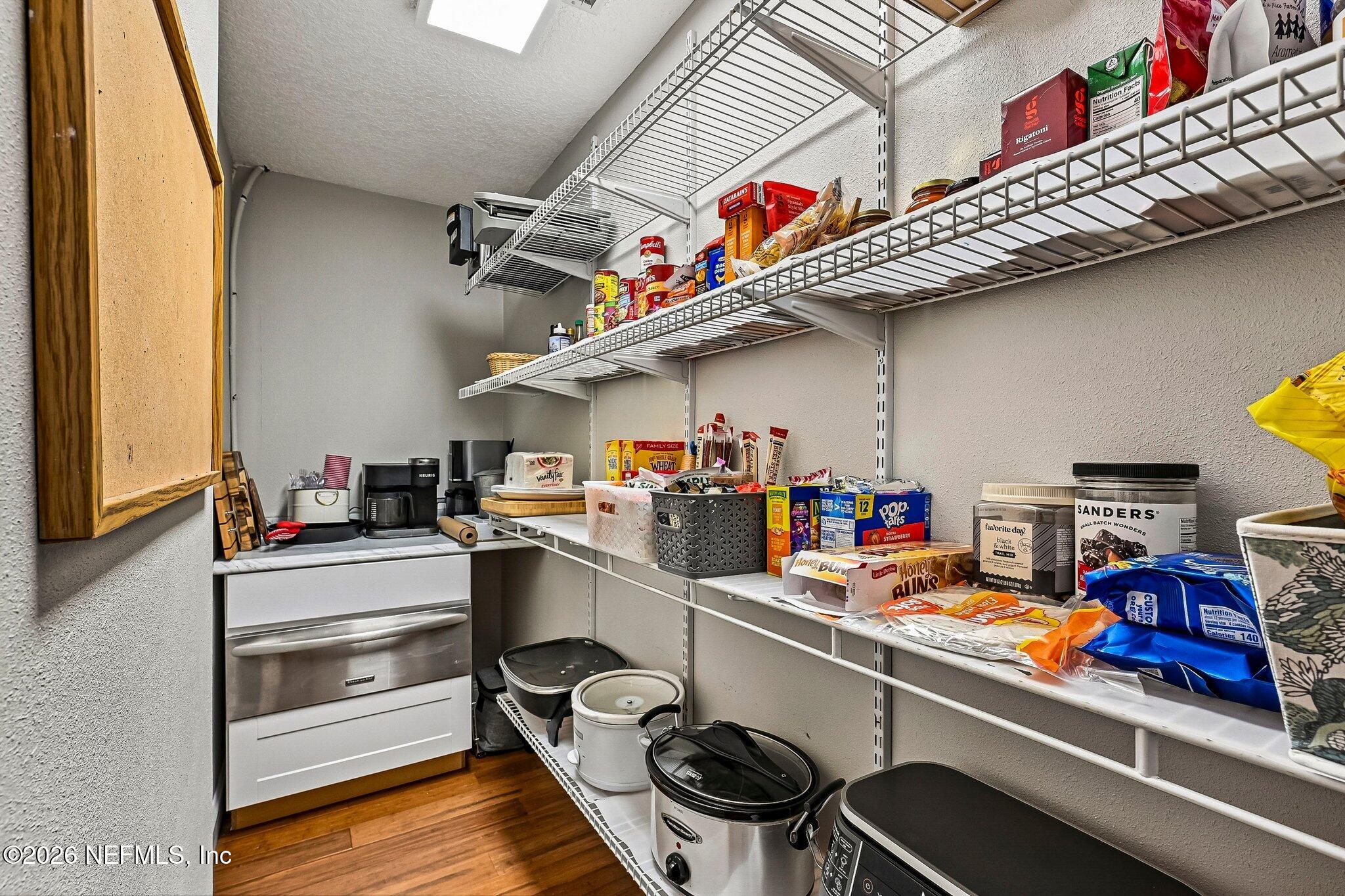 4745 Raggedy Point Road Fleming Island, FL 32003 - Photo 26 of 106 a storage room with stainless steel appliances and wooden floor