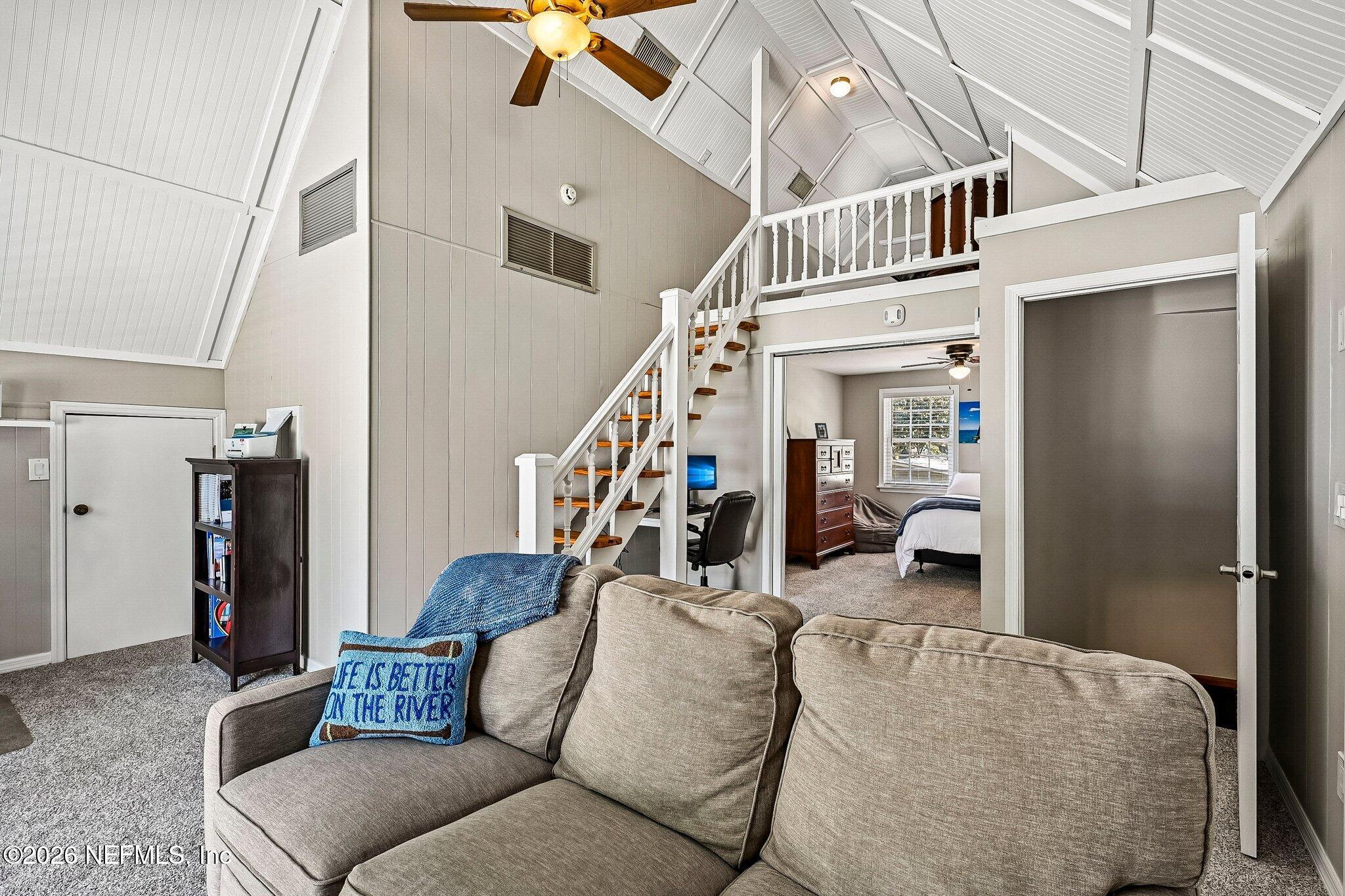 4745 Raggedy Point Road Fleming Island, FL 32003 - Photo 43 of 106 a living room with furniture and stairs