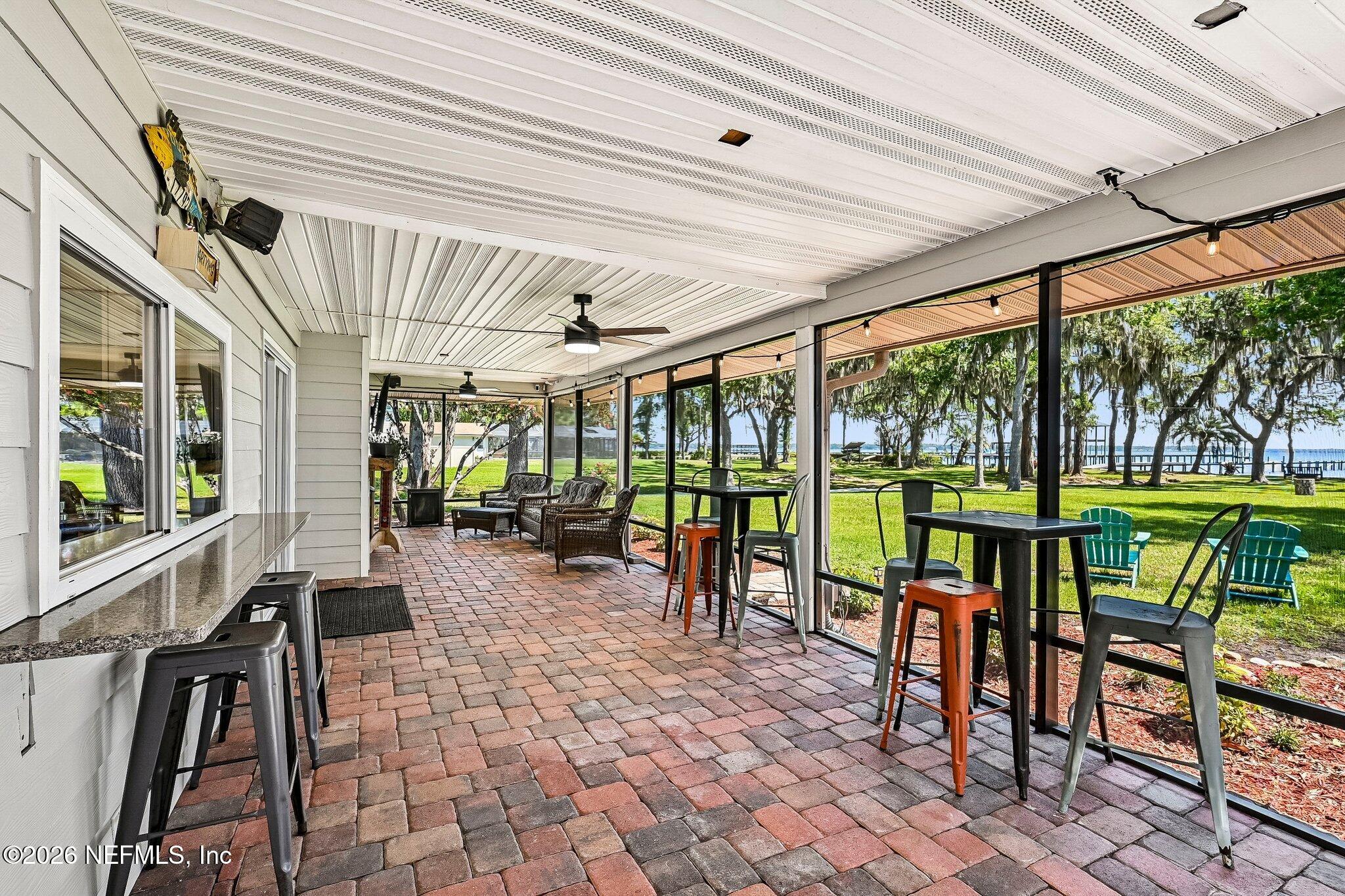 4745 Raggedy Point Road Fleming Island, FL 32003 - Photo 54 of 106 a view of a dining hall with a large window and furniture