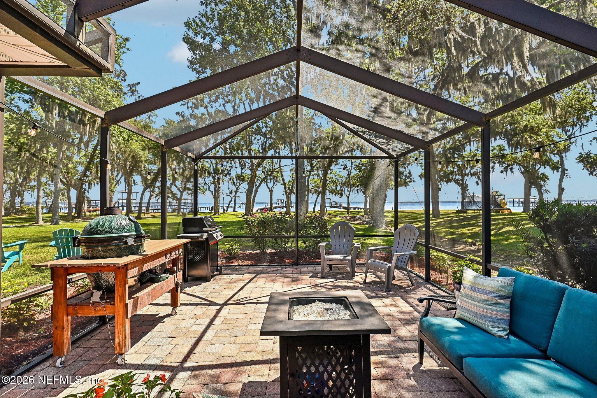 4745 Raggedy Point Road Fleming Island, FL 32003 - Photo 56 of 106 a view of a patio with couches table and chairs and potted plants