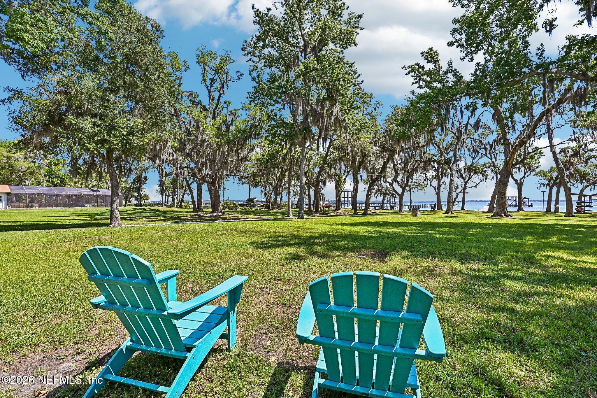 4745 Raggedy Point Road Fleming Island, FL 32003 - Photo 58 of 106 a backyard of a house with outdoor seating