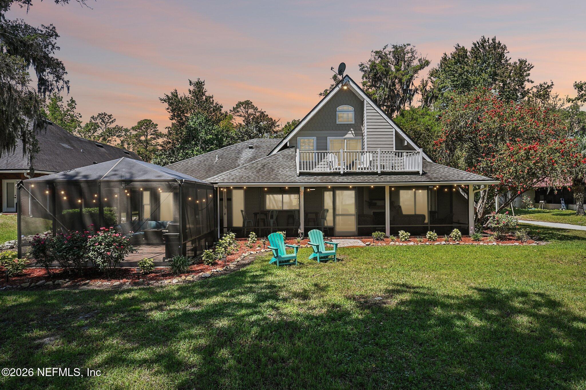 4745 Raggedy Point Road Fleming Island, FL 32003 - Photo 79 of 106 a front view of a house with garden