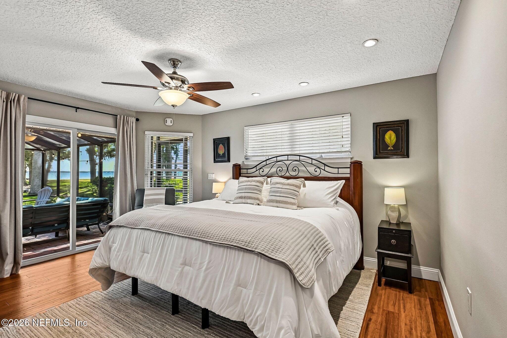 4745 Raggedy Point Road Fleming Island, FL 32003 - Photo 8 of 106 a bedroom with a large bed and a large window