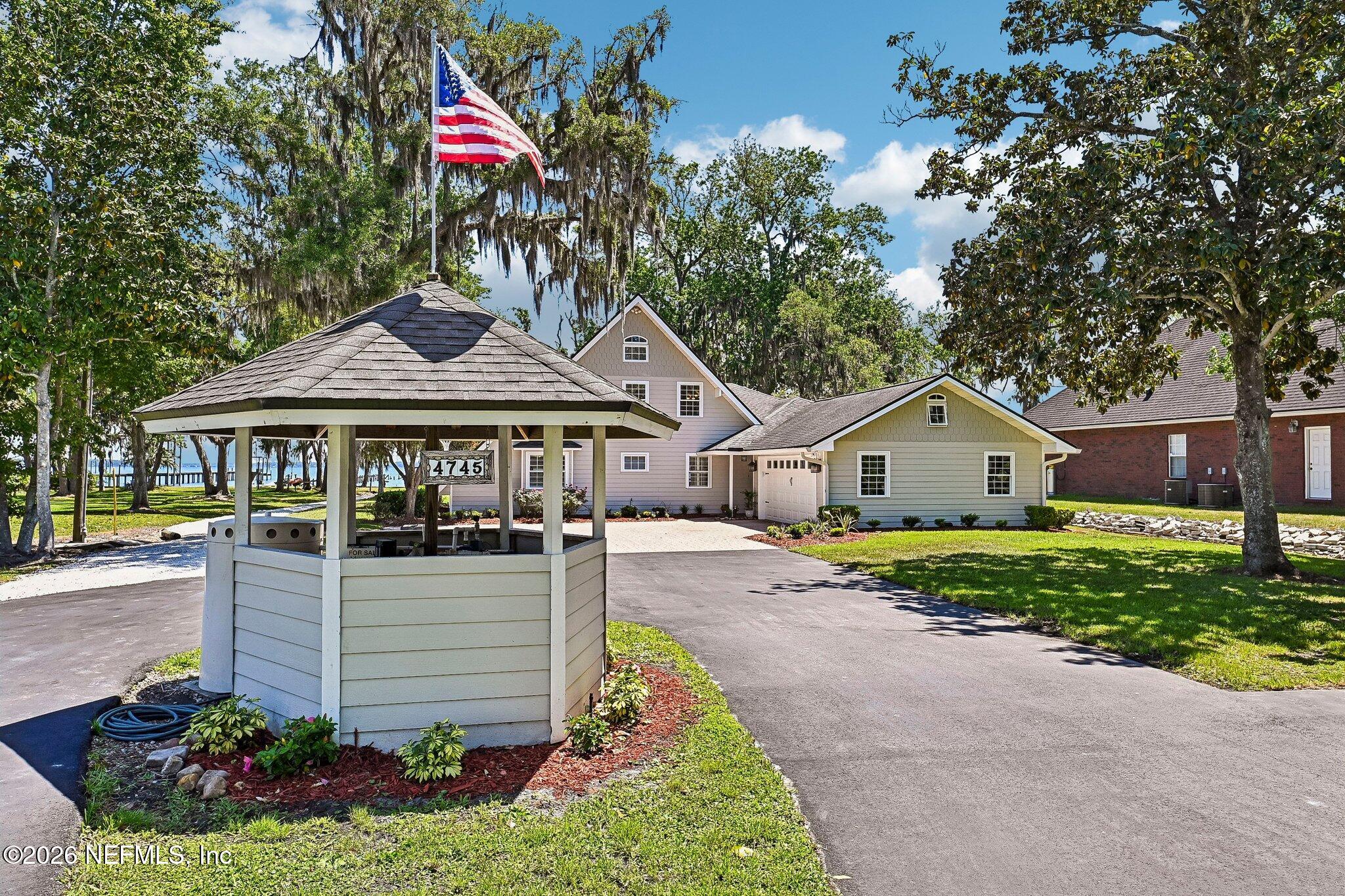 4745 Raggedy Point Road Fleming Island, FL 32003 - Photo 85 of 106 a front view of a house with garden