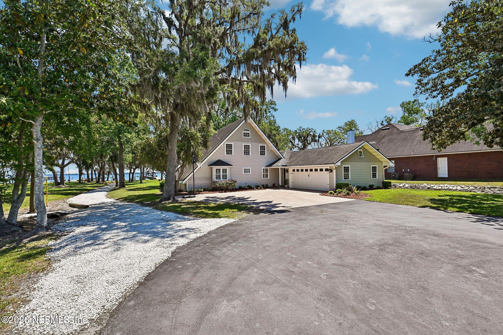 4745 Raggedy Point Road Fleming Island, FL 32003 - Photo 86 of 106 a front view of a house with a yard and garage