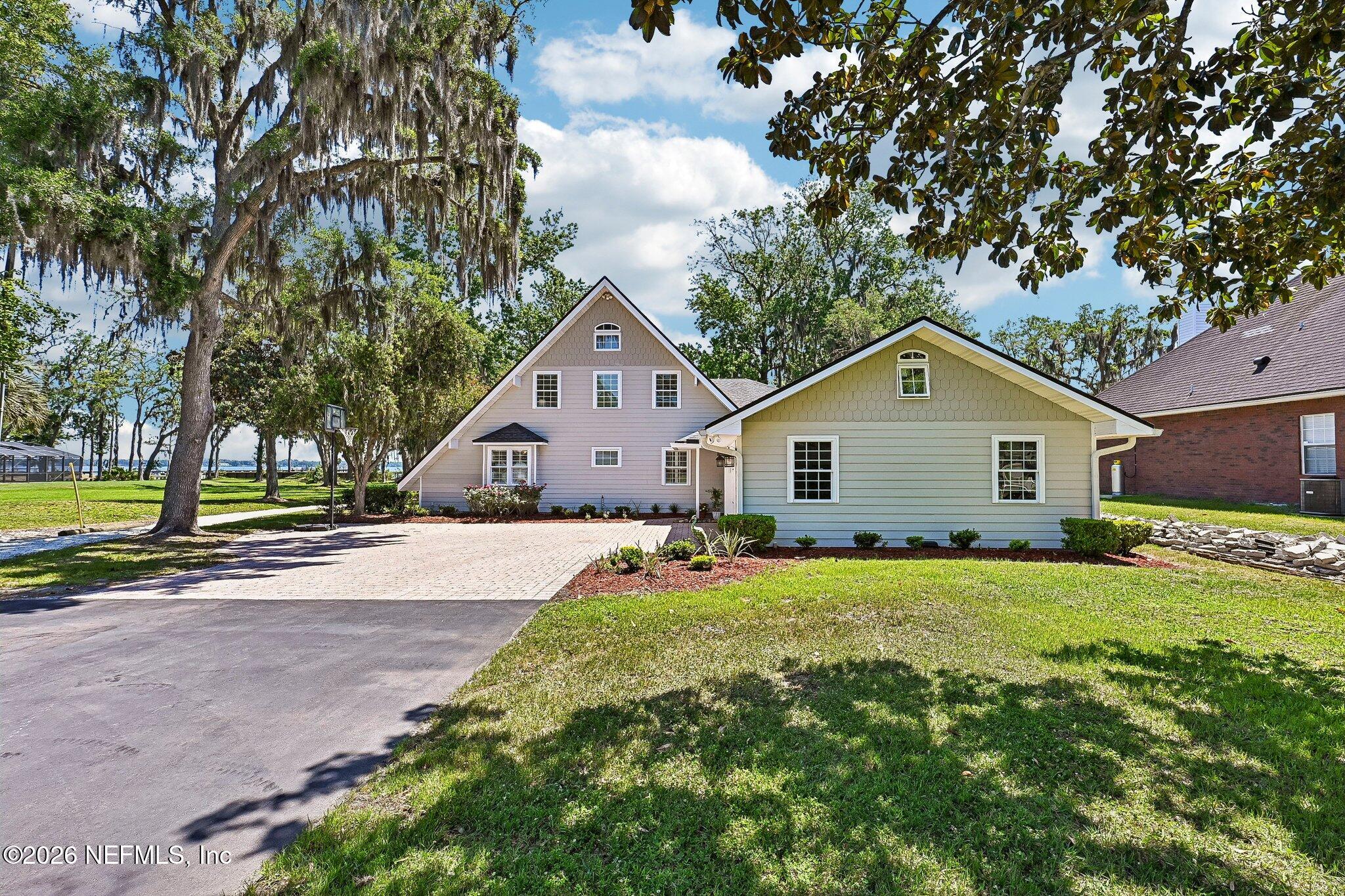 4745 Raggedy Point Road Fleming Island, FL 32003 - Photo 87 of 106 a front view of a house with a yard and garage