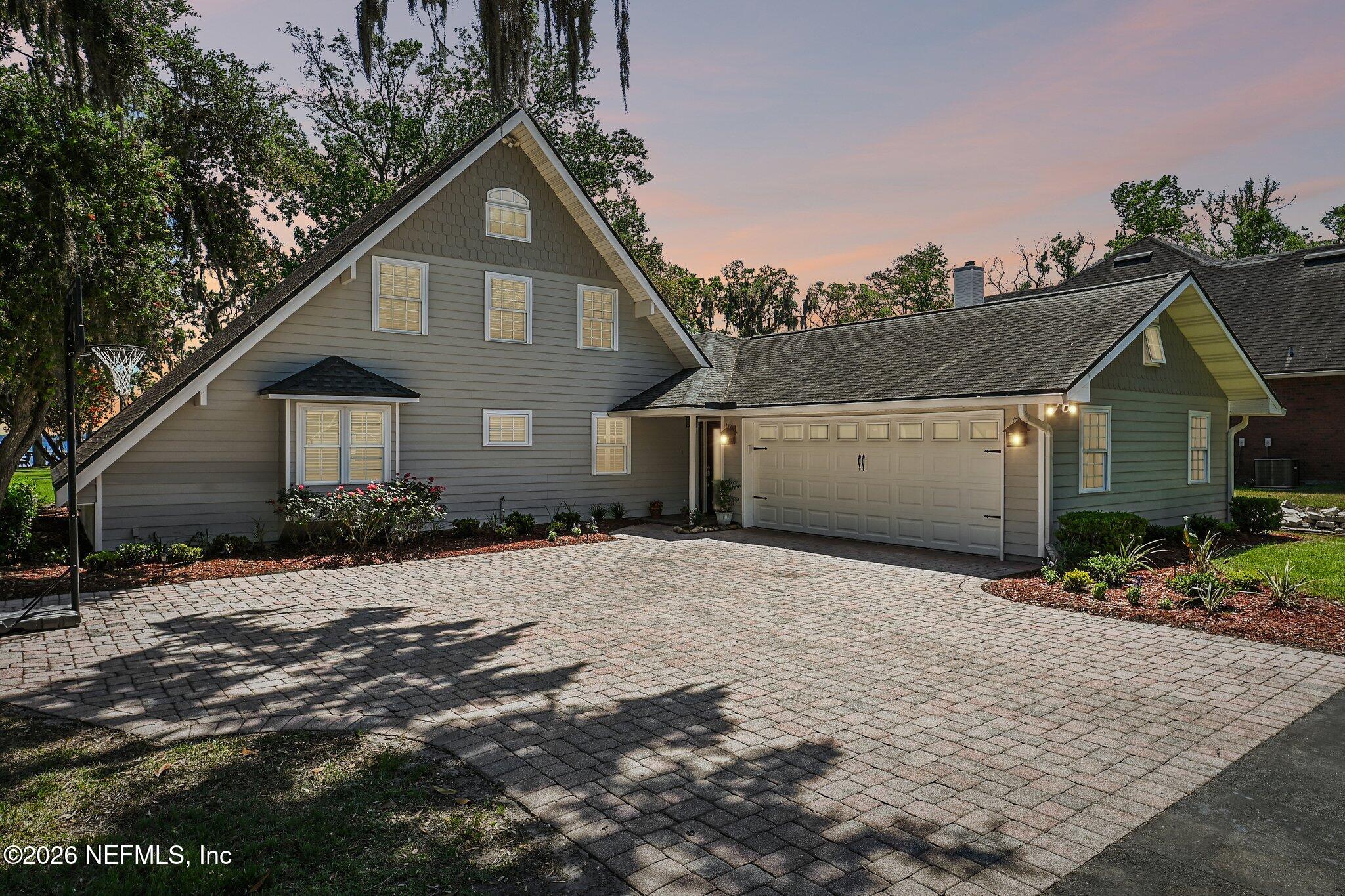 4745 Raggedy Point Road Fleming Island, FL 32003 - Photo 90 of 106 a front view of a house with a yard and garage